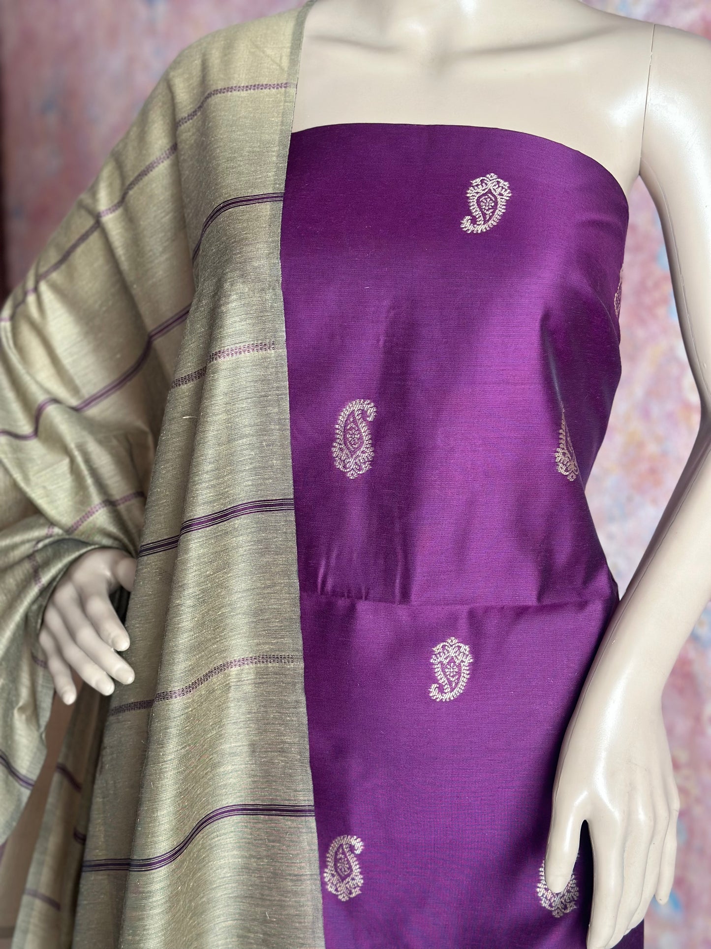 Front detail of purple silk cotton paisley fabric with contrasting striped dupatta.