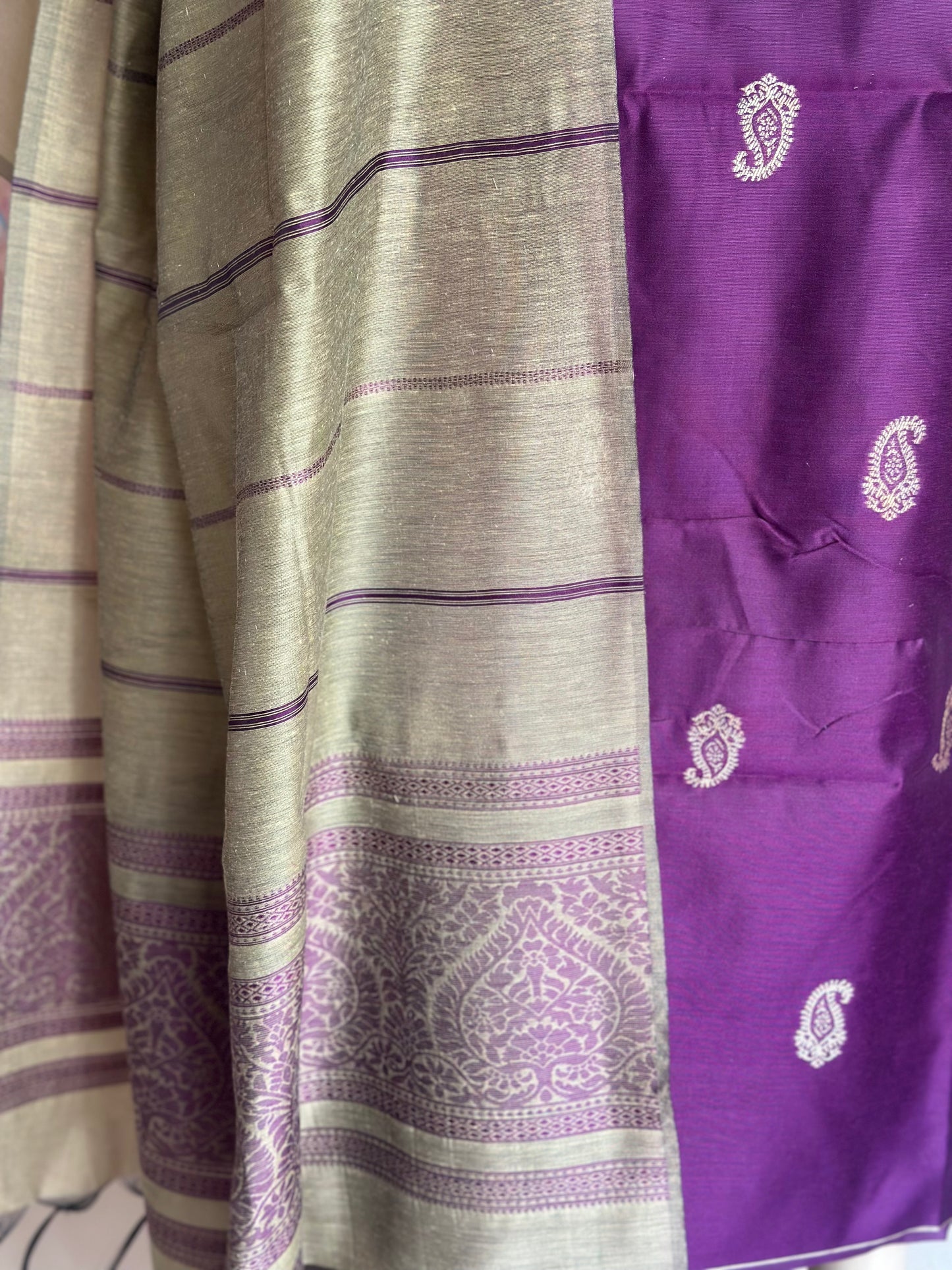 Close-up of purple paisley motifs and the decorative purple border on the contrasting dupatta.