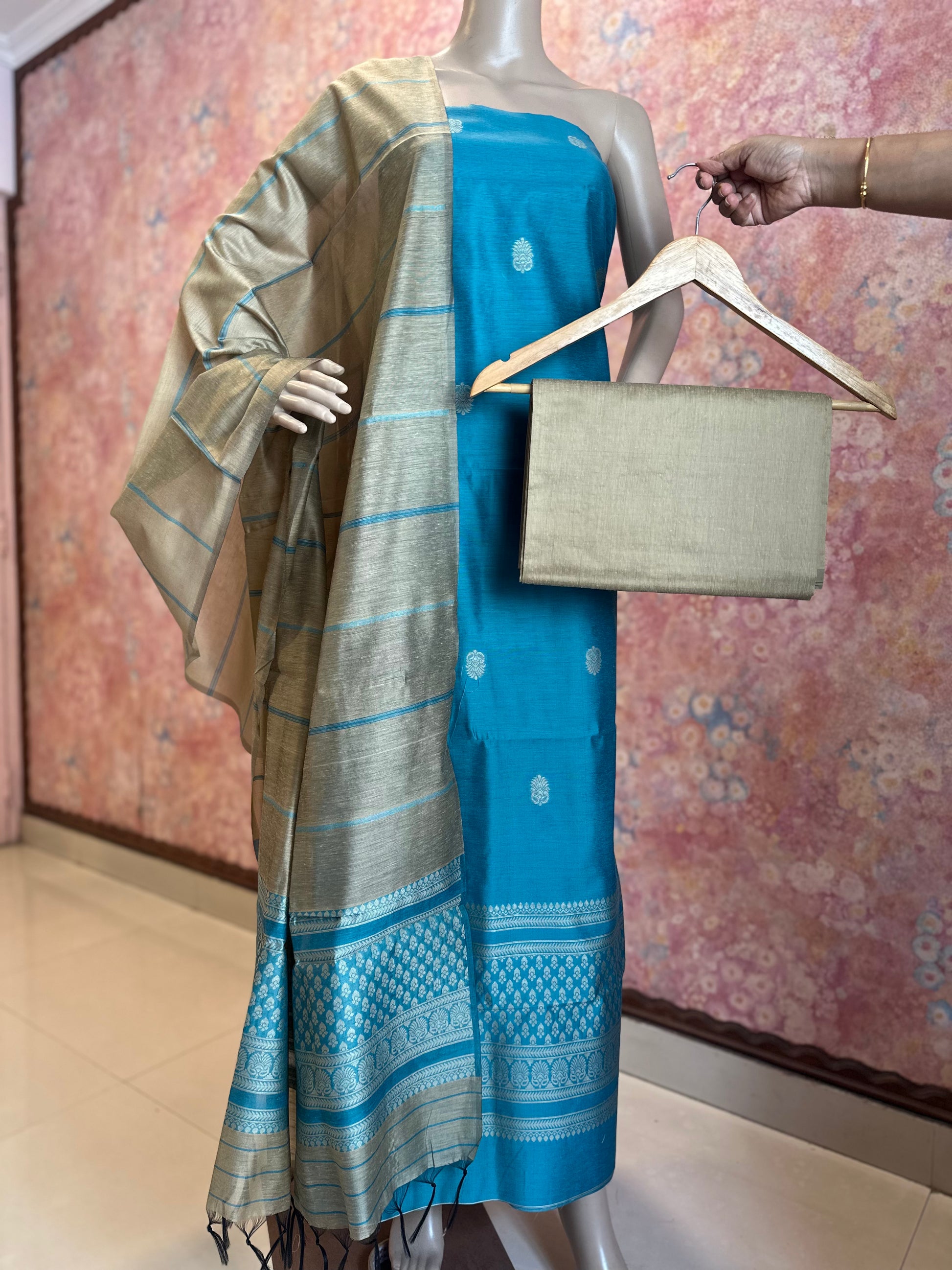 Full-length display of Light Blue unstitched suit fabrics showing the decorative dupatta border and coordinating bottom