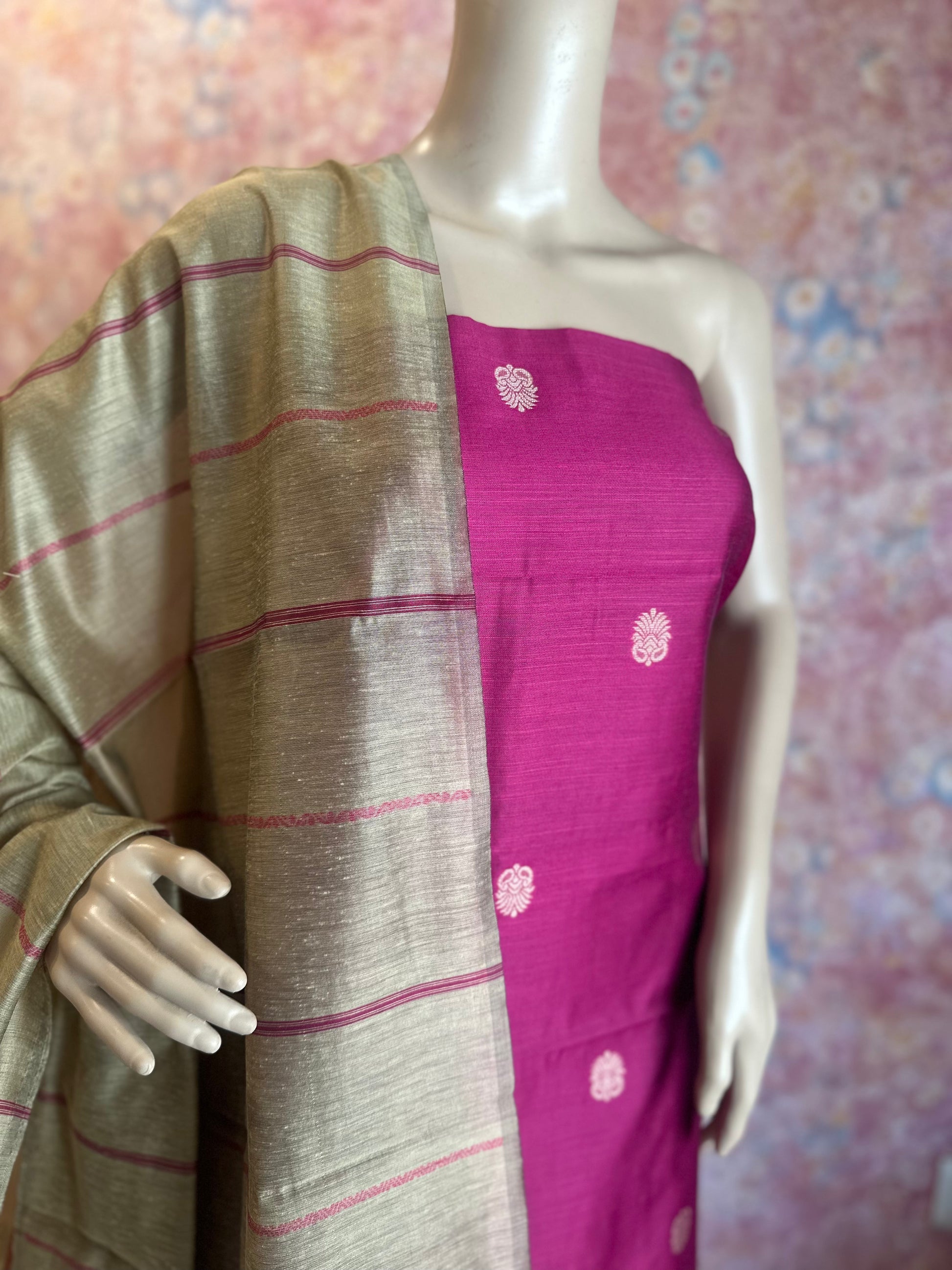 Angled detail of Dark Pink top fabric and silver-beige dupatta with pink stripes