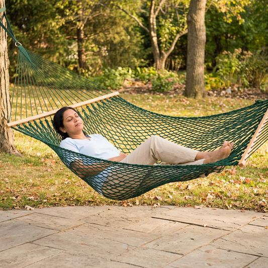 Person relaxing in the solid-green hammock